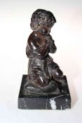 Small bronze of child seated on cushion, 22cm.