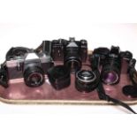 Praktica, Zenit and Minolta cameras and two lenses.