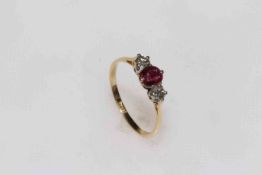 18 carat gold ruby and diamond three-stone ring, size R.