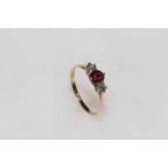 18 carat gold ruby and diamond three-stone ring, size R.