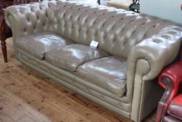 Taupe deep buttoned leather three seater Chesterfield settee, length 200cm.