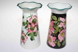 Two Wemyss ware Grosvenor vases each decorated with a version of wild roses, 21cm high.