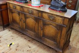 Period style oak dresser having three drawers above three arched fielded panel doors, 79cm by 168cm.
