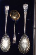 Cased pair of silver serving spoons with shell bowls and sifting spoon, Sheffield 1902/05.
