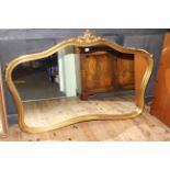 Shaped gilt framed overmantel mirror, 100cm by 149cm overall.