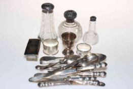 Four silver topped toilet bottles, two napkin rings, egg cup and flatware.