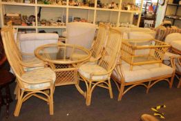 Cane conservatory furniture comprising circular glass topped table and four chairs,
