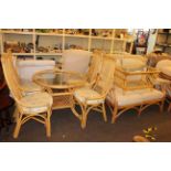 Cane conservatory furniture comprising circular glass topped table and four chairs,