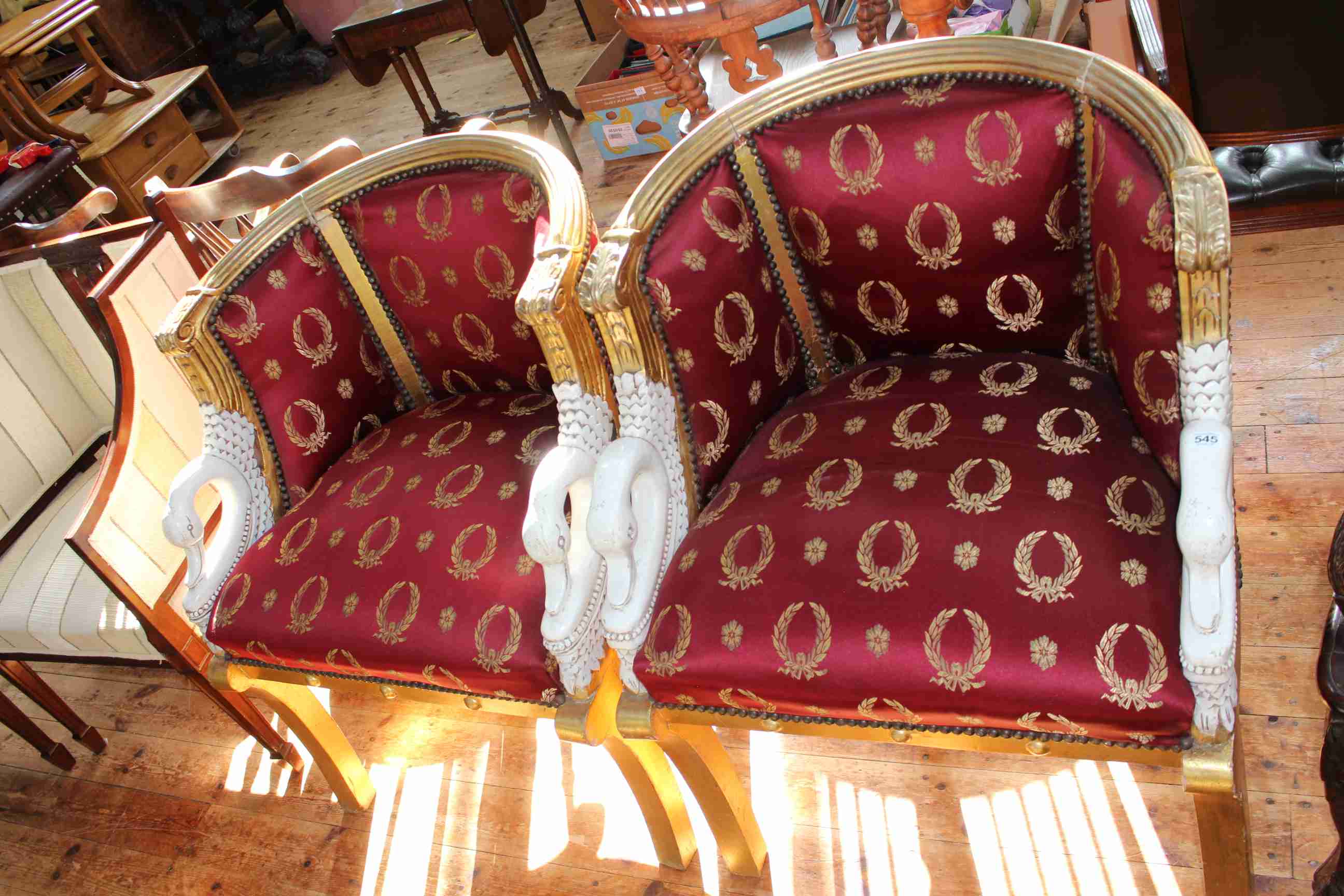 Pair gilt and white painted occasional chairs with swan neck arms.