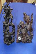Two elaborate Asian wood carvings of figure and dragon, and two female figures, 51cm and 42cm.