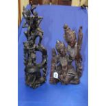 Two elaborate Asian wood carvings of figure and dragon, and two female figures, 51cm and 42cm.