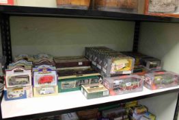 Shelf collection of boxed Diecast toy cars including Corgi, Days Gone, Lledo,