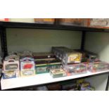 Shelf collection of boxed Diecast toy cars including Corgi, Days Gone, Lledo,