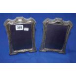 Pair silver mounted easel photograph frames, having husk borders, 18cm by 14cm.