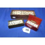 Three sets of ivory/bone dominoes, including miniatures.
