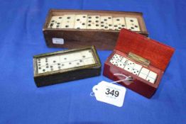 Three sets of ivory/bone dominoes, including miniatures.