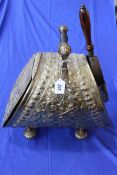 Ornate embossed brass coal scuttle with shovel.