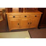 Light oak three door side cabinet, 83cm by 138cm.