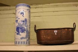 Copper two handled pan and a blue and white stick stand (2).