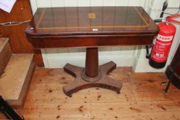 Victorian inlaid rosewood fold top card table on turned pedestal to inverted quadriform base,