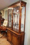 Good quality mahogany cabinet having two glazed panel doors above a pull out leather surface with