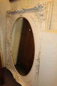 Large Dutch ivory coloured framed oval wall mirror, 157cm by 126cm overall.