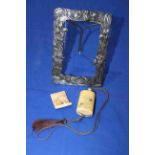 Japanese silver easel photograph frame together with unusual netsuke of face and spider, signed,
