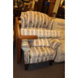 Reclining wing armchair in classical striped fabric and matching long stool.