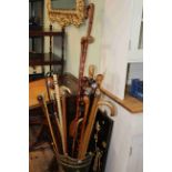 Collection of walking sticks including shark vertebrae, silver collared, wood knots, horn,