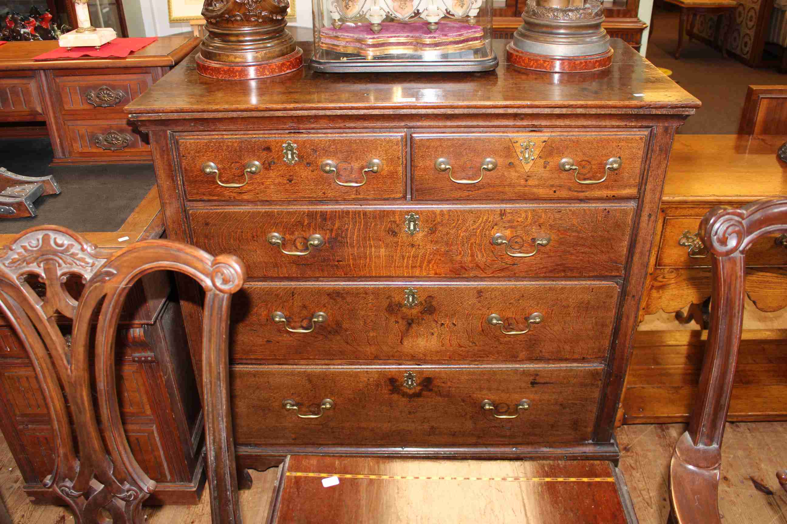 Georgian oak chest of two short above three long graduated drawers on shaped bracket feet,