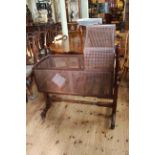 Victorian mahogany and bergere panelled rocking crib and stand, 122cm by 102cm.