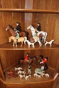 Collection of Beswick comprising Huntsman, Huntswoman with nine hounds and two foxes,