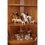 Collection of Beswick comprising Huntsman, Huntswoman with nine hounds and two foxes,