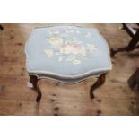 Cabriole leg stool of serpentine form with floral needlework seat, 43cm by 51cm.