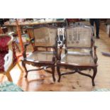 Pair bergere panelled carved mahogany elbow chairs.