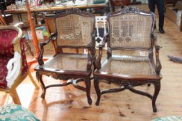 Pair bergere panelled carved mahogany elbow chairs.