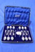 Cased set of twelve silver teaspoons with tongs having pierced and engraved handles, Sheffield 1912.