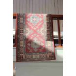 Oriental wool runner with a rose ground, 4.00 by 0.85.