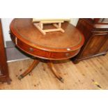 Mahogany leather inset topped revolving drum table having three drawers and five faux drawers on