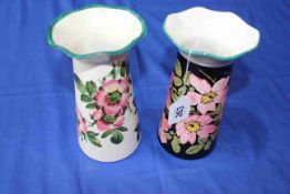 Two Wemyss Grosvenor vases decorated with wild roses, 21cm.