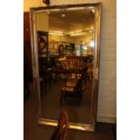 Large silvered framed bevelled wall mirror, 173cm by 93cm overall.