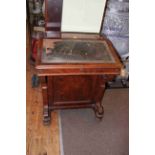 Victorian walnut Davenport having opposing arched panelled side doors both enclosing four drawers,