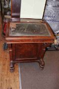 Victorian walnut Davenport having opposing arched panelled side doors both enclosing four drawers,