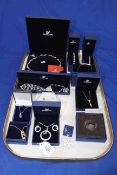 Boxed pieces of Swarovski jewellery including bangles, necklaces and pendants.