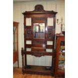 Late Victorian carved oak mirror back hallstand, 224cm by 113cm.