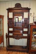 Late Victorian carved oak mirror back hallstand, 224cm by 113cm.