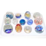 Collection of thirteen glass paperweights.