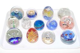 Collection of thirteen glass paperweights.