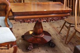 Victorian mahogany fold top tea table on octagonal form pedestal and four paw feet,