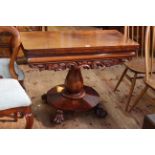 Victorian mahogany fold top tea table on octagonal form pedestal and four paw feet,